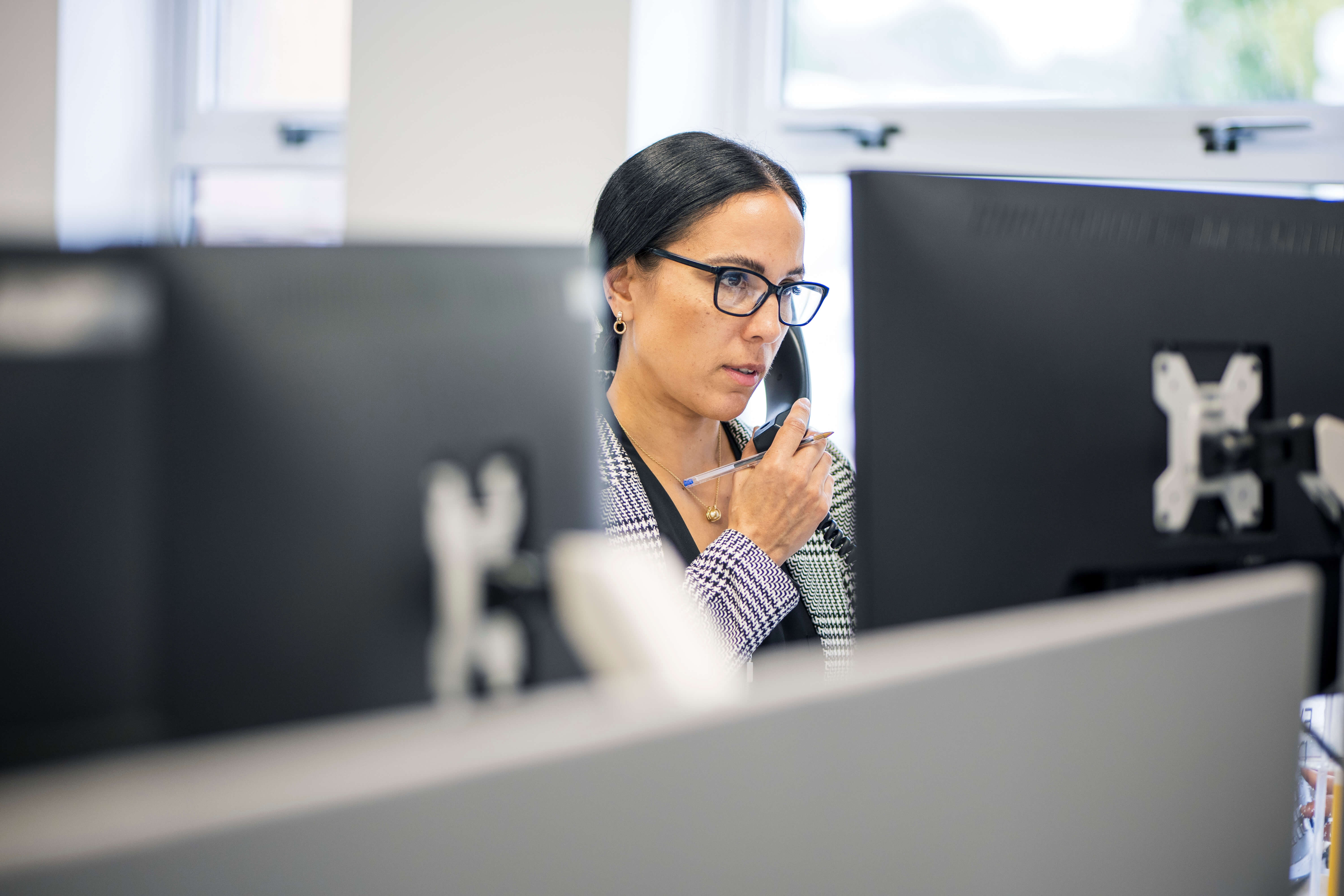 Headley Media colleague on the phone at her desk
