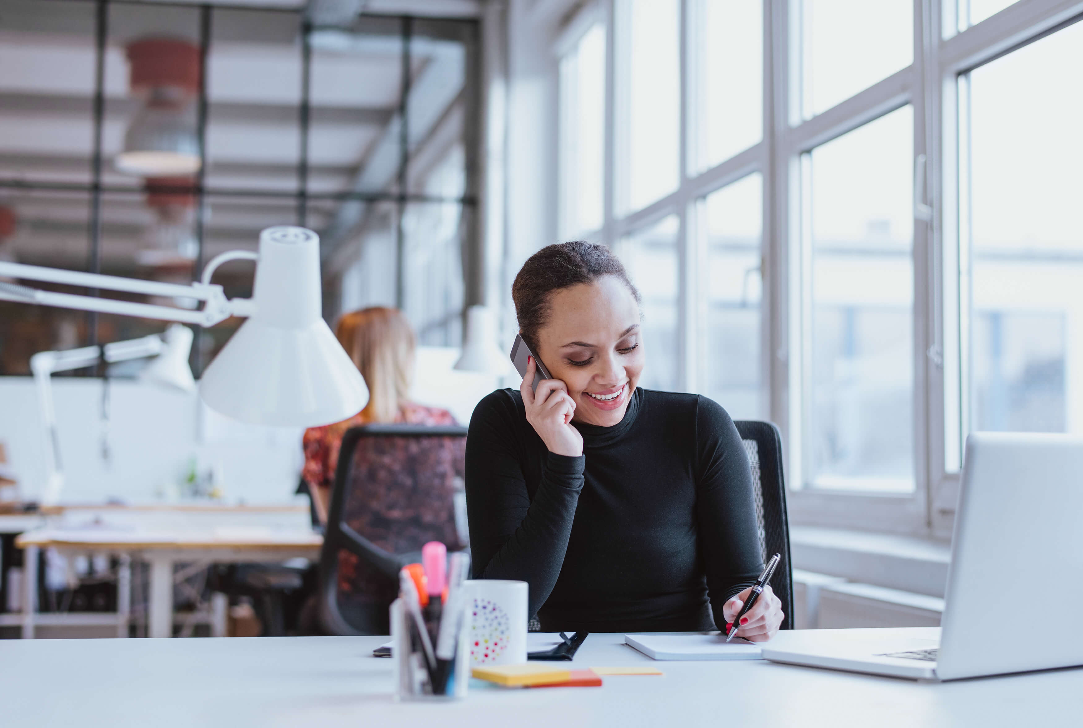 Headley Media colleague on the phone at her desk
